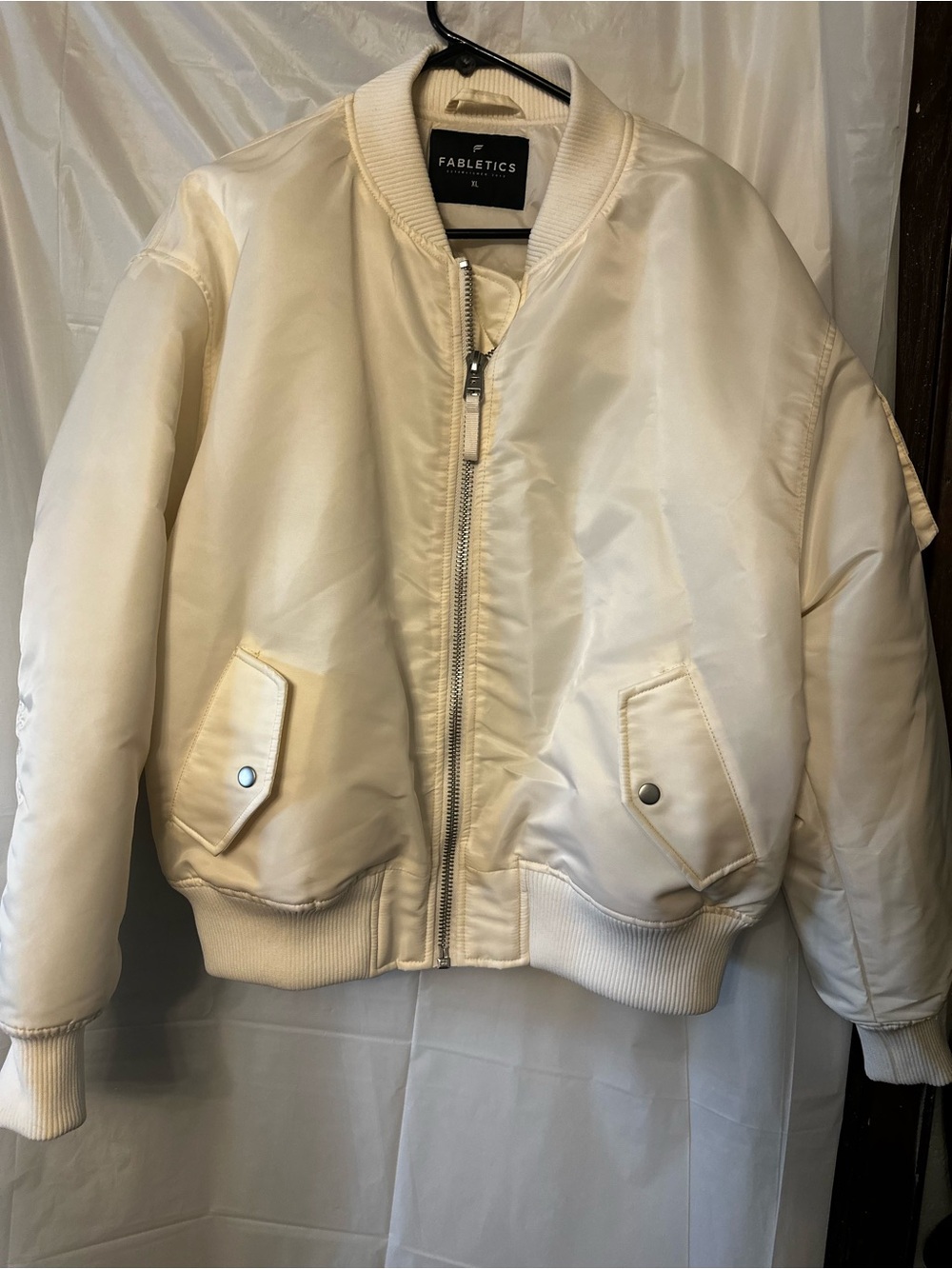 Fabletics Iconic Bomber Jacket in an off-white or cream color.